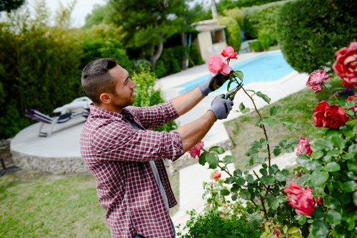 Well-equipped gardeners wearing PPE while performing maintenance tasks
