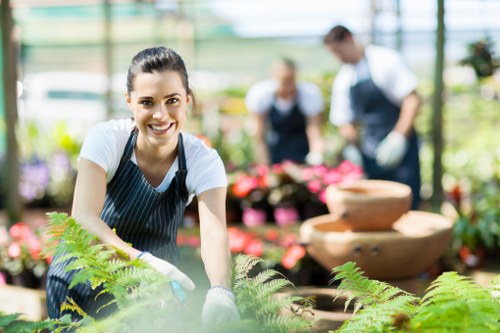 Worker planting shrubs during a community garden maintenance project